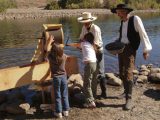 docents showing children how to run sluice box