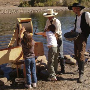 docents showing children how to run sluice box